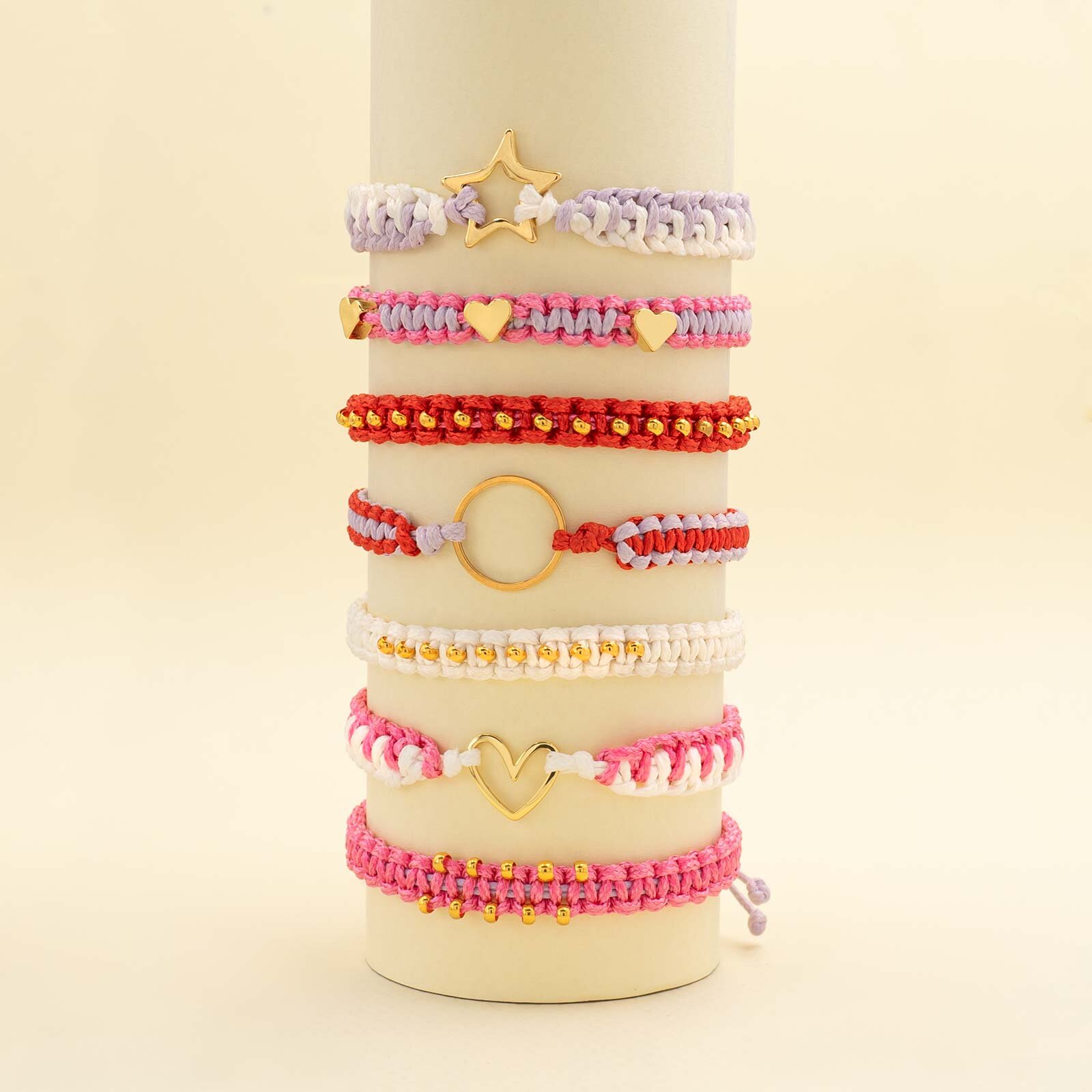 mehrere Makramee Armbänder in Rosa, Rot und Weiß