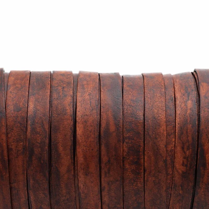 Dunkelbraunes flaches Lederband, eng nebeneinander auf einer Spule aufgewickelt, Frontalansicht vor weißem Hintergrund mit sichtbarer Ledernarbung und unregelmäßig schattierter Färbung