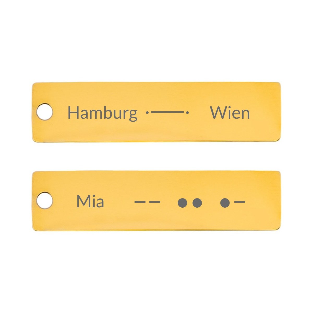 Zwei Gravurplättchen: Hamburg und Wien verbunden durch eine Linie, der Name Mia in Morsezeichen